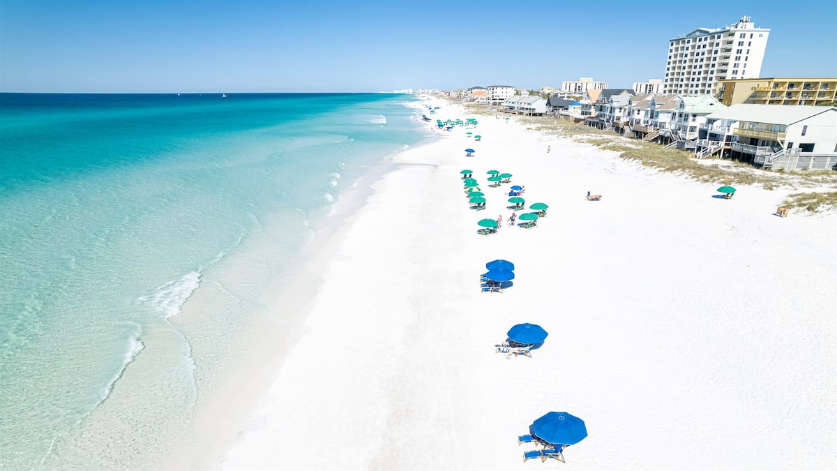 White sand and emerald water at the Gulf Winds private beach