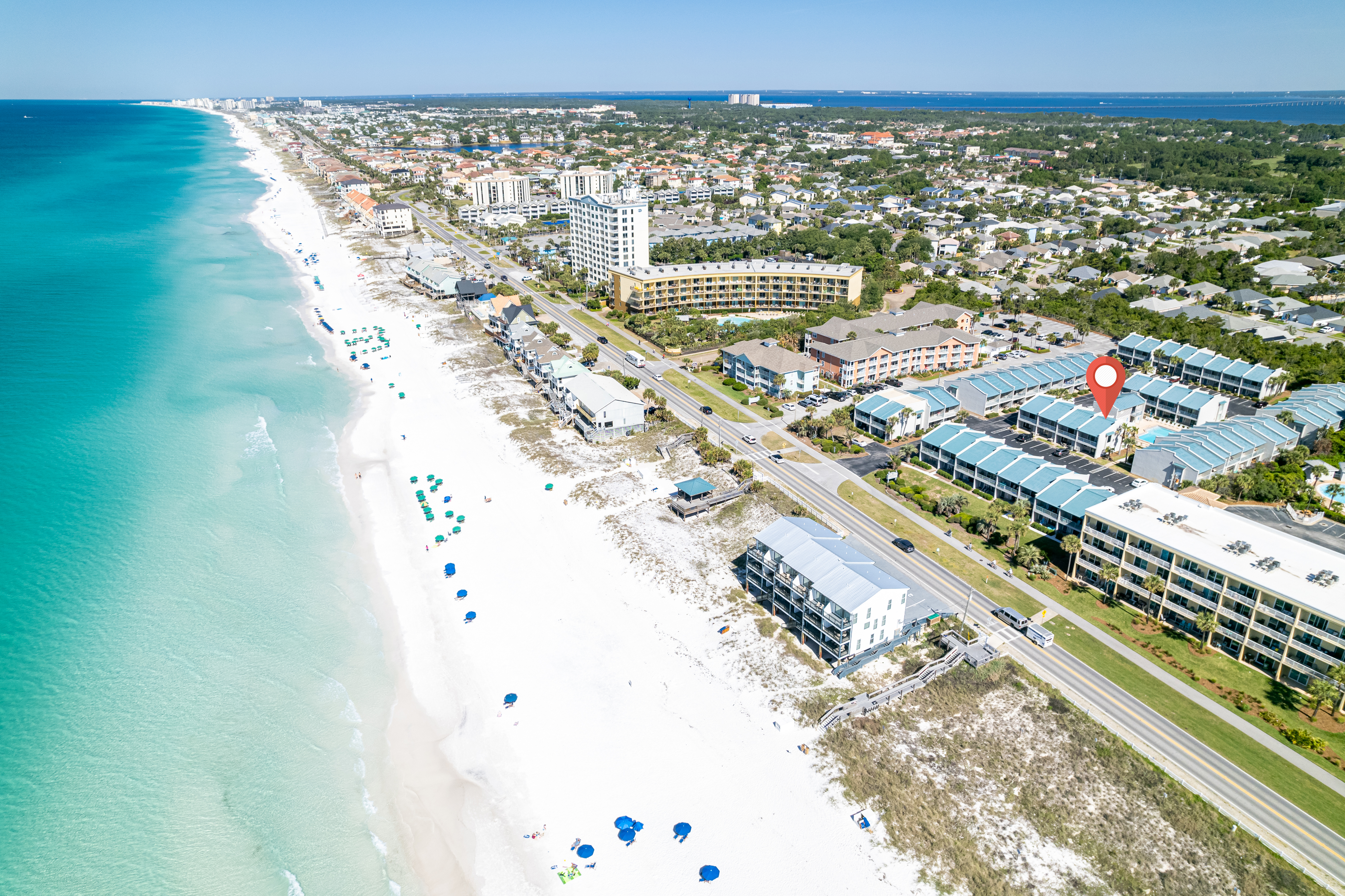 Aerial view of Miramar Beach and Gulf Winds East with a red marker identifying the townhome
